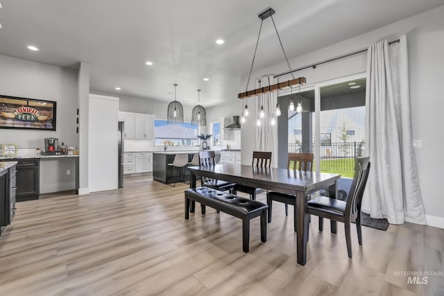 dining room with light wood-style flooring and recessed lighting