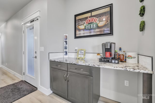 bar with baseboards and light wood-style floors