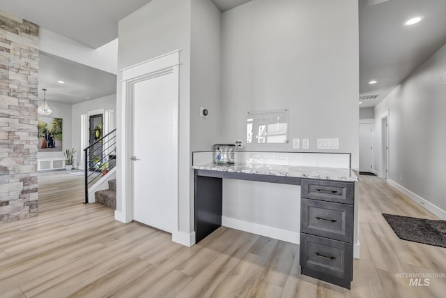 kitchen with light stone counters, gray cabinetry, recessed lighting, visible vents, and light wood-style floors