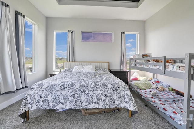 carpeted bedroom featuring baseboards