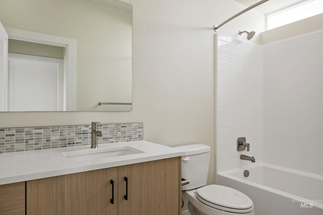 bathroom with shower / tub combination, vanity, toilet, and decorative backsplash