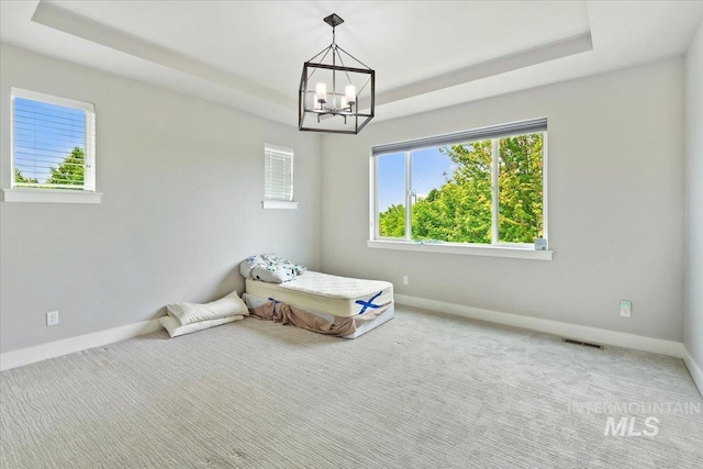 3303 S Island Fox Ave, Eagle, ID 83616 - unfurnished bedroom featuring baseboards, a chandelier, a tray ceiling, and carpet