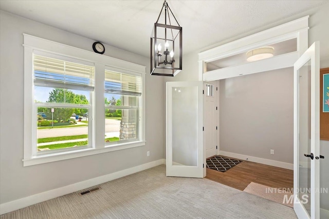 3303 S Island Fox Ave, Eagle, ID 83616 - unfurnished dining area featuring a chandelier, baseboards, and carpet floors