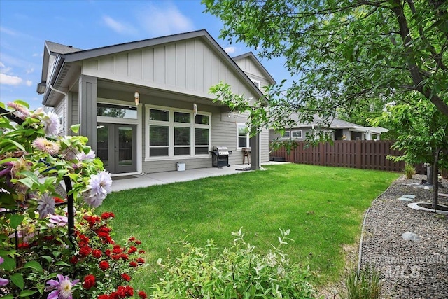 3303 S Island Fox Ave, Eagle, ID 83616 - back of property with board and batten siding, french doors, and a patio area