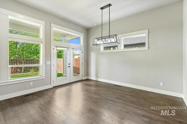 3303 S Island Fox Ave, Eagle, ID 83616 - unfurnished dining area featuring baseboards, french doors, and wood finished floors