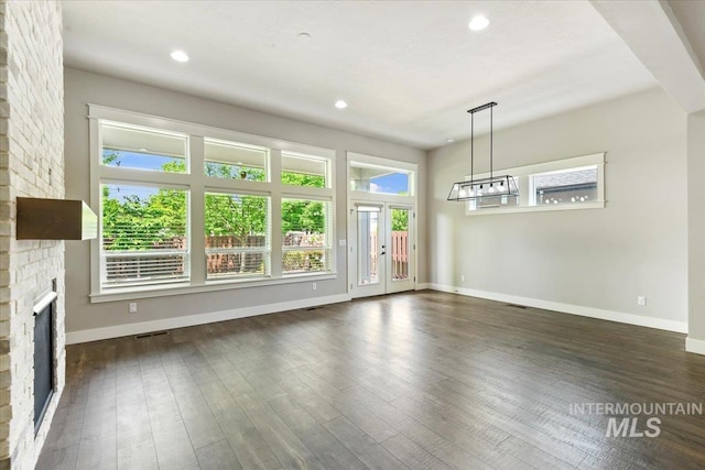 3303 S Island Fox Ave, Eagle, ID 83616 - unfurnished living room featuring a fireplace, baseboards, dark wood-style flooring, and recessed lighting