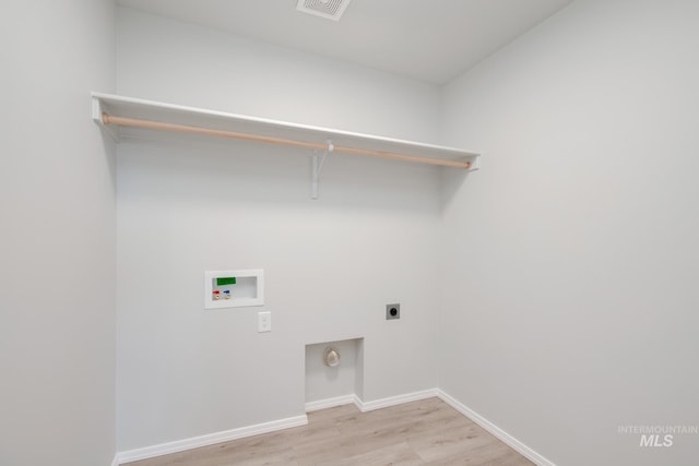 laundry area with washer hookup, laundry area, electric dryer hookup, light wood-style flooring, and baseboards