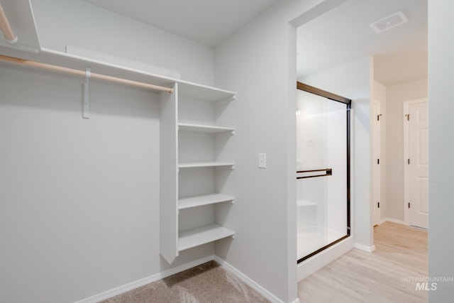 spacious closet with visible vents and wood finished floors