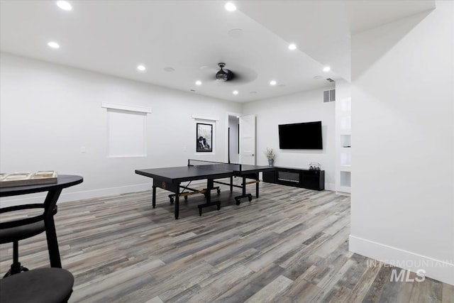 recreation room with ceiling fan and wood-type flooring