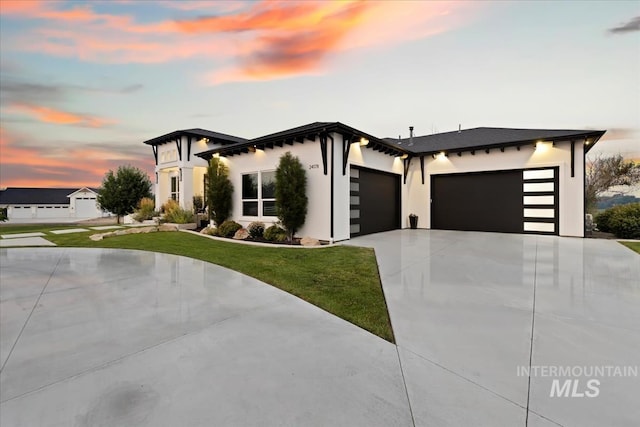 view of front of house with a garage and a lawn