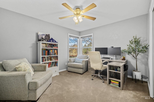 office area featuring light carpet and ceiling fan