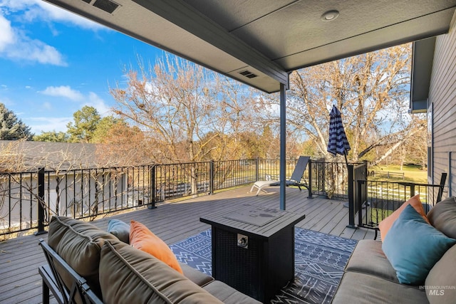 wooden deck featuring an outdoor living space