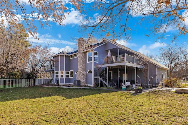 rear view of property with a yard and cooling unit