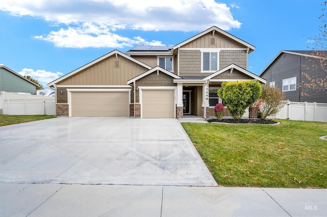 craftsman house featuring a garage, a front yard, and solar panels