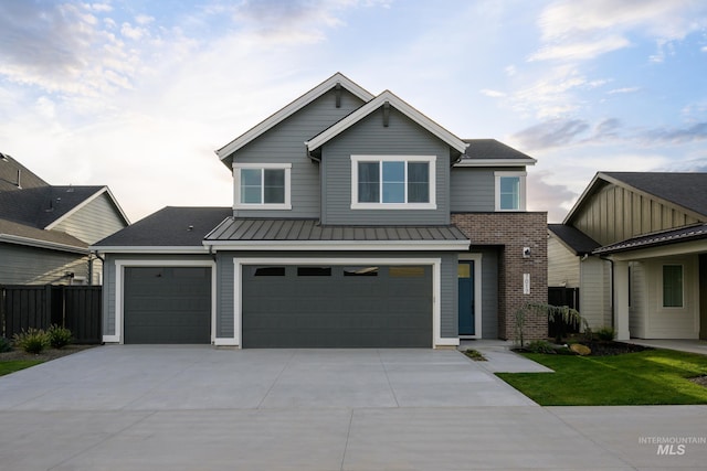 7017 S Zenith Ave, Meridian, ID 83642 - view of front of property featuring driveway, an attached garage, a standing seam roof, metal roof, and fence