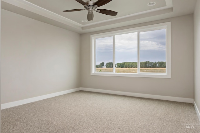 7017 S Zenith Ave, Meridian, ID 83642 - spare room featuring baseboards, a raised ceiling, carpet flooring, and a ceiling fan