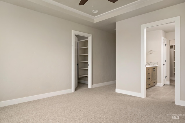 7017 S Zenith Ave, Meridian, ID 83642 - unfurnished bedroom featuring light carpet, baseboards, a ceiling fan, and a raised ceiling