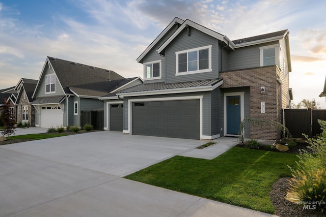 7017 S Zenith Ave, Meridian, ID 83642 - view of front of home with a standing seam roof, fence, brick siding, an attached garage, and driveway