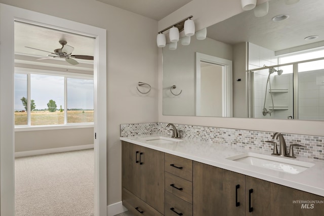 7017 S Zenith Ave, Meridian, ID 83642 - full bathroom featuring a sink, decorative backsplash, a stall shower, and baseboards
