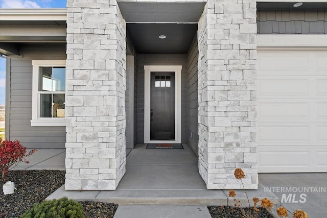 doorway to property with a garage