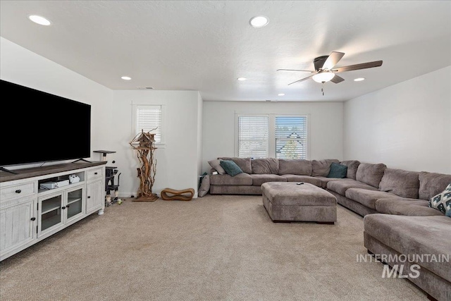 living room featuring ceiling fan and light carpet