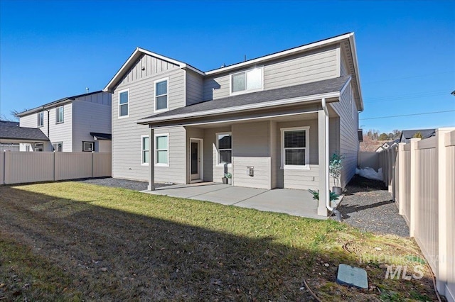 back of property featuring a lawn and a patio area