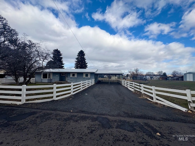 view of front of home featuring a fenced front yard and a rural view