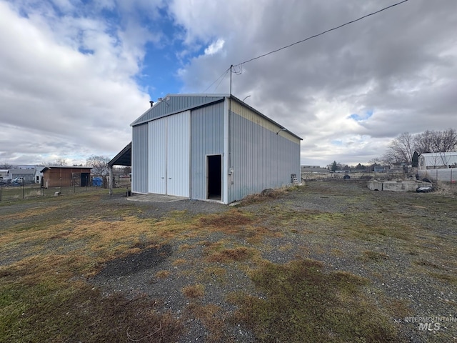 view of pole building featuring fence