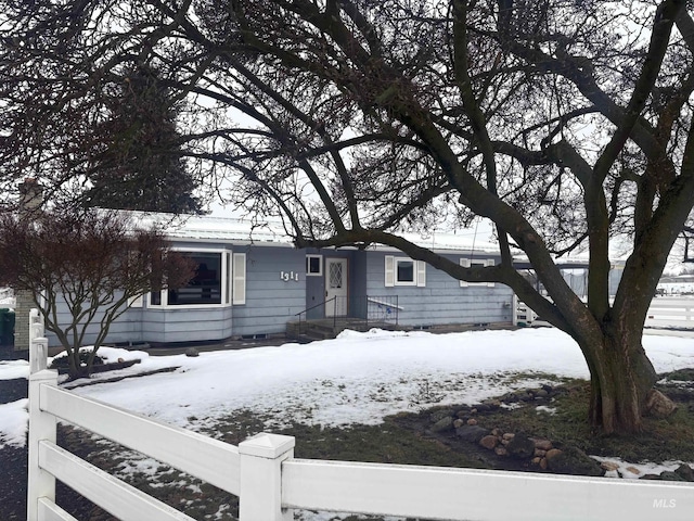 ranch-style home with a fenced front yard