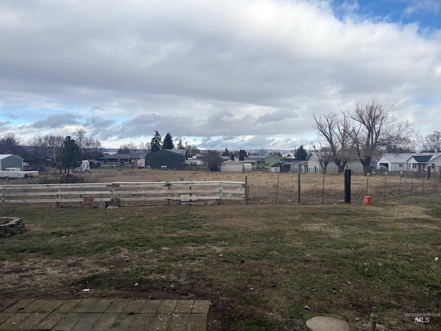 view of yard featuring fence and a residential view