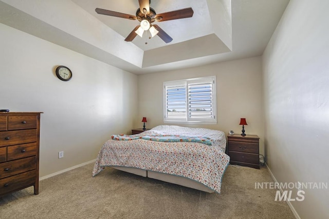 741 Gregory Way, Twin Falls, ID 83301 - bedroom featuring a tray ceiling, carpet flooring, baseboards, and a ceiling fan