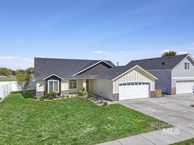 741 Gregory Way, Twin Falls, ID 83301 - craftsman-style house featuring stone siding, an attached garage, concrete driveway, board and batten siding, and roof with shingles