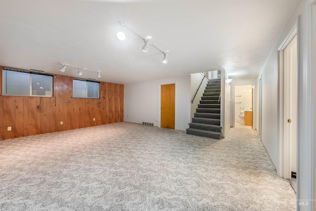 18822 Chicken Dinner Rd, Caldwell, ID 83607 - basement with light carpet, wood walls, and rail lighting