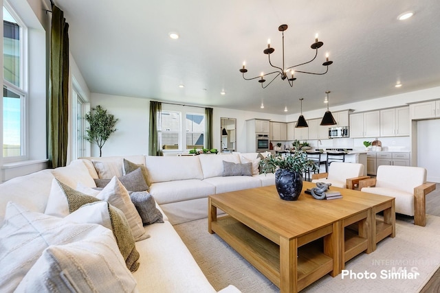 living area with recessed lighting and a notable chandelier