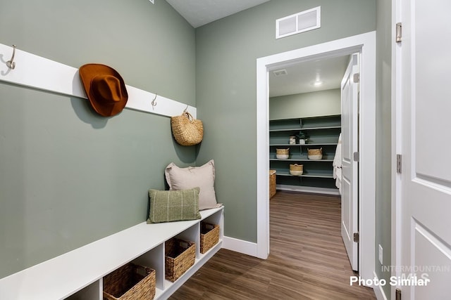 mudroom featuring baseboards, wood finished floors, and visible vents