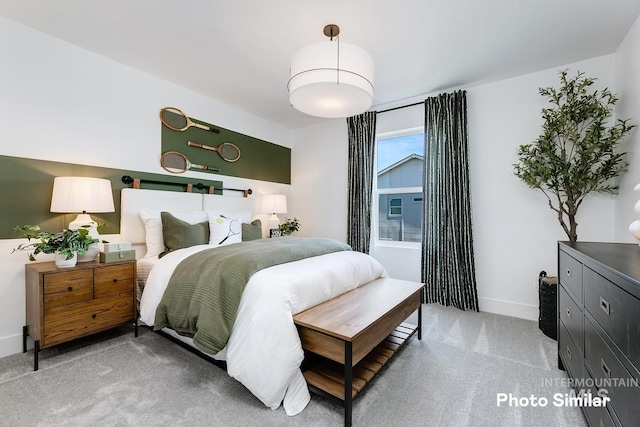 bedroom featuring light colored carpet and baseboards