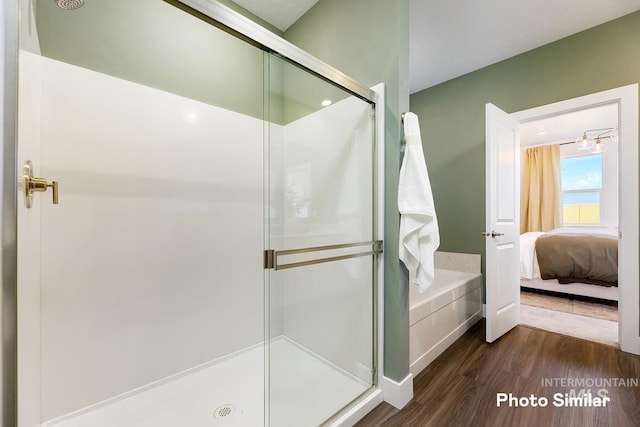 full bathroom featuring wood finished floors, ensuite bathroom, and a stall shower