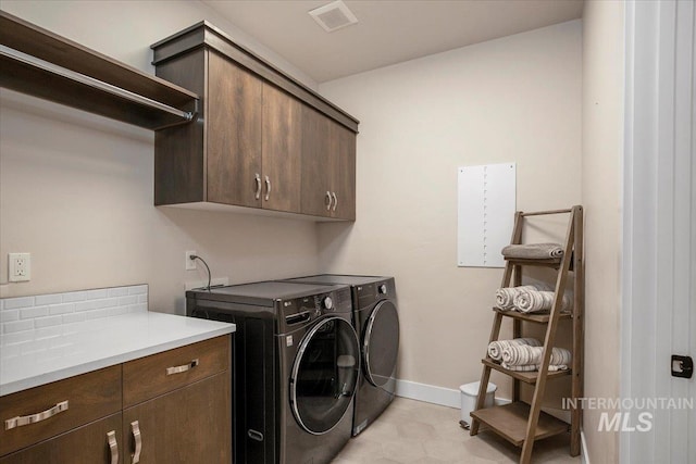 clothes washing area featuring cabinet space, independent washer and dryer, visible vents, and baseboards