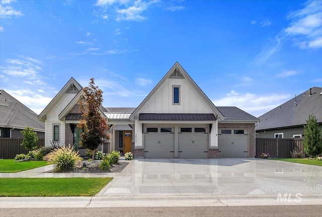 view of front of home featuring a standing seam roof, brick siding, board and batten siding, and fence