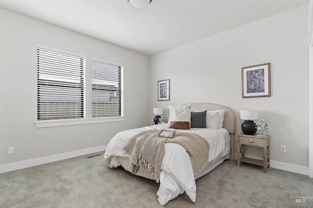 carpeted bedroom with visible vents and baseboards