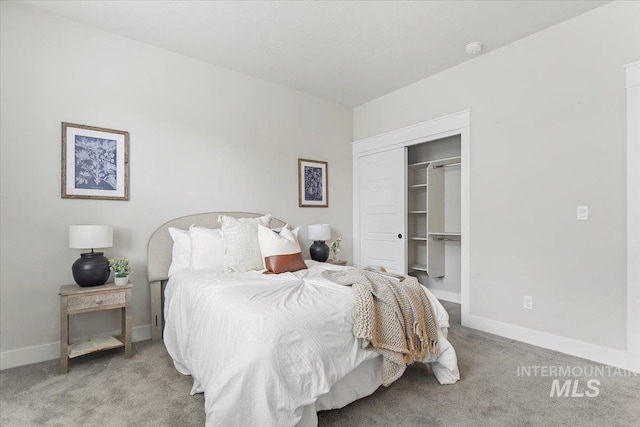 carpeted bedroom with a closet and baseboards