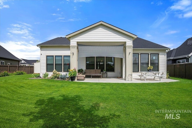 rear view of house featuring a patio area, fence, an outdoor hangout area, and a lawn