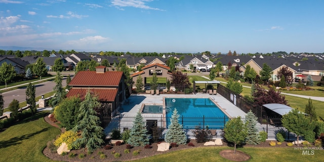 view of pool with fence and a residential view