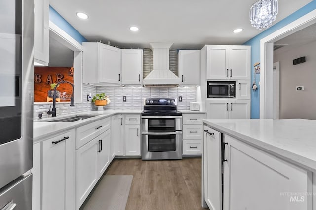 15201 Christopher, Caldwell, ID 83607 - kitchen featuring stainless steel appliances, a sink, custom exhaust hood, white cabinets, and recessed lighting