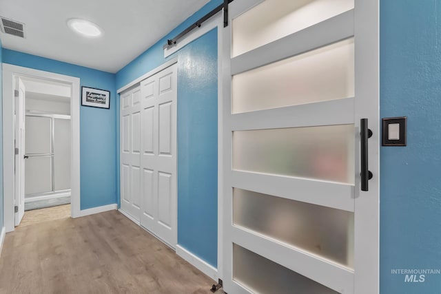 15201 Christopher, Caldwell, ID 83607 - hallway featuring wood finished floors, baseboards, and a barn door