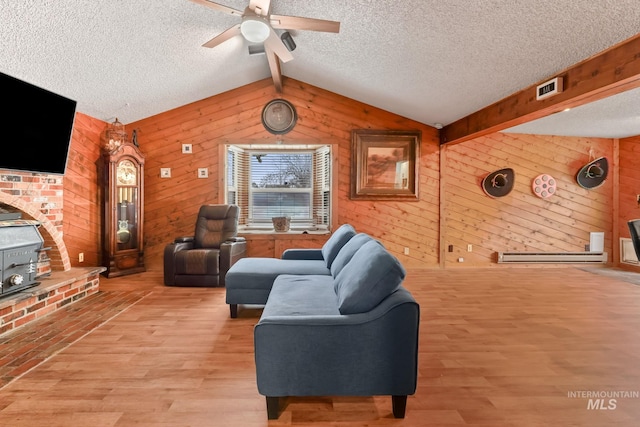 15201 Christopher, Caldwell, ID 83607 - living area with wood walls, light wood finished floors, a ceiling fan, a textured ceiling, and a baseboard radiator