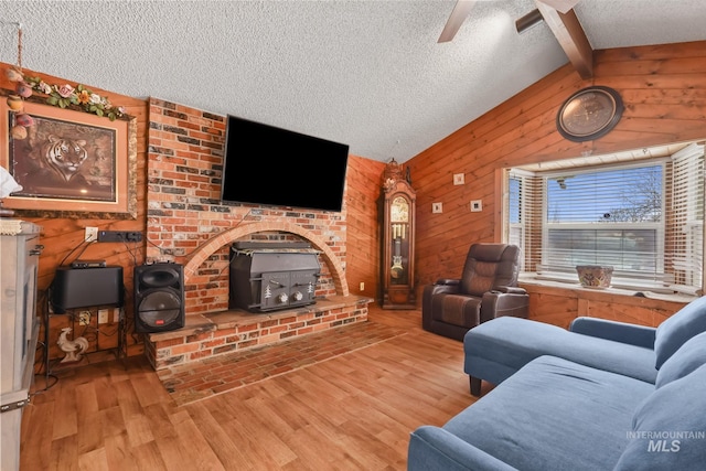 15201 Christopher, Caldwell, ID 83607 - living area with a textured ceiling, a wood stove, wood finished floors, wood walls, and ceiling fan