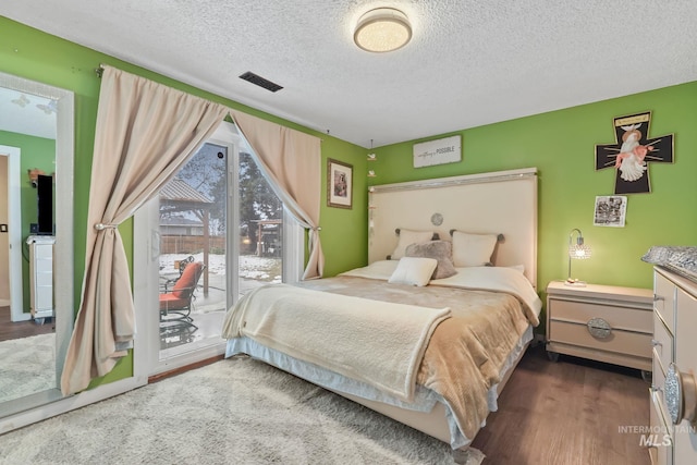 15201 Christopher, Caldwell, ID 83607 - bedroom featuring access to exterior, wood finished floors, and a textured ceiling