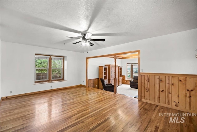 4523 N Mountain View Dr, Boise, ID 83704 - spare room with ceiling fan, wood finished floors, plenty of natural light, wainscoting, and a textured ceiling