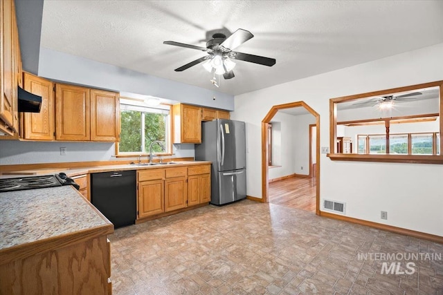 4523 N Mountain View Dr, Boise, ID 83704 - kitchen featuring freestanding refrigerator, black dishwasher, ceiling fan, and light countertops
